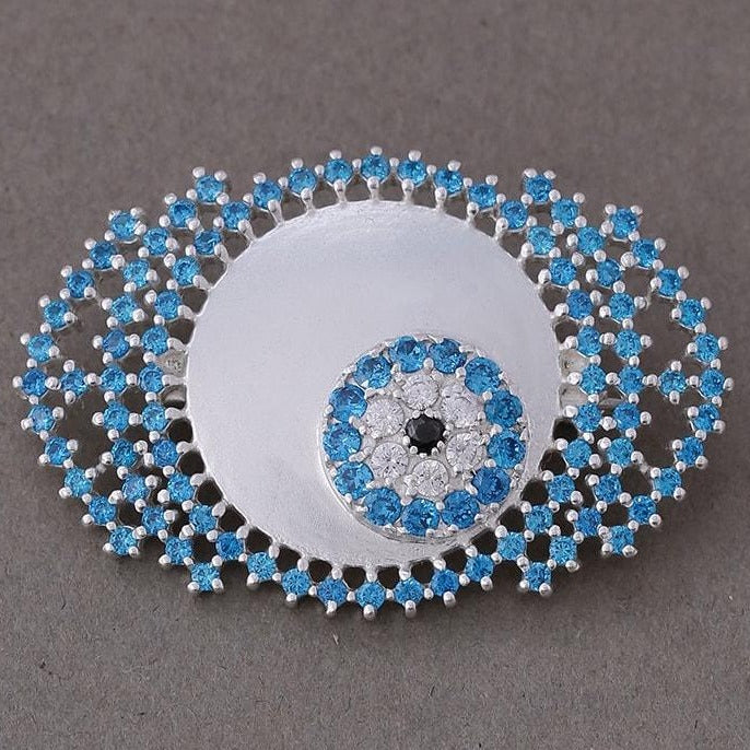 Blue zircon studded evil eye brooch
