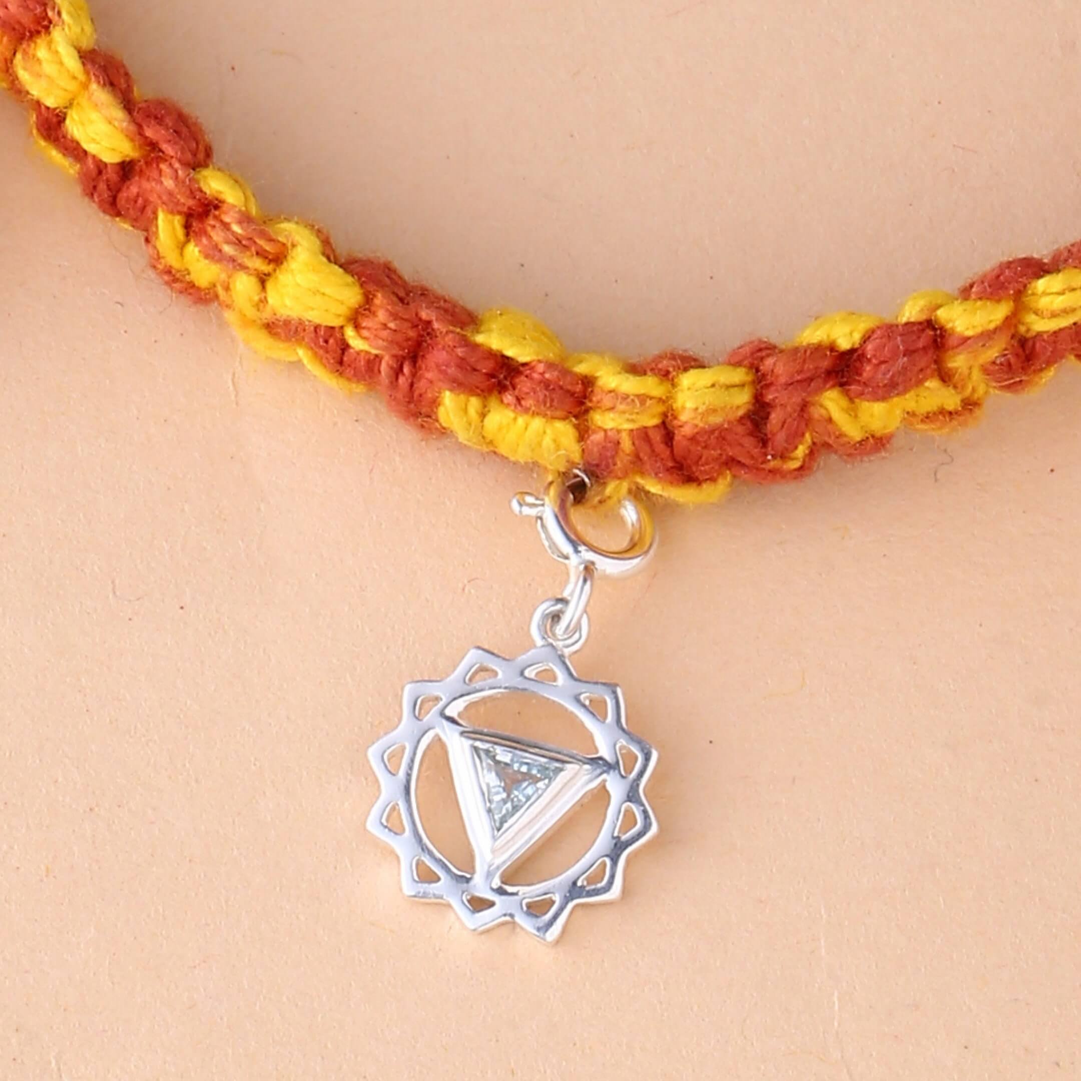 silver Vishuddha chakra rakhi with blue topaz gemstone