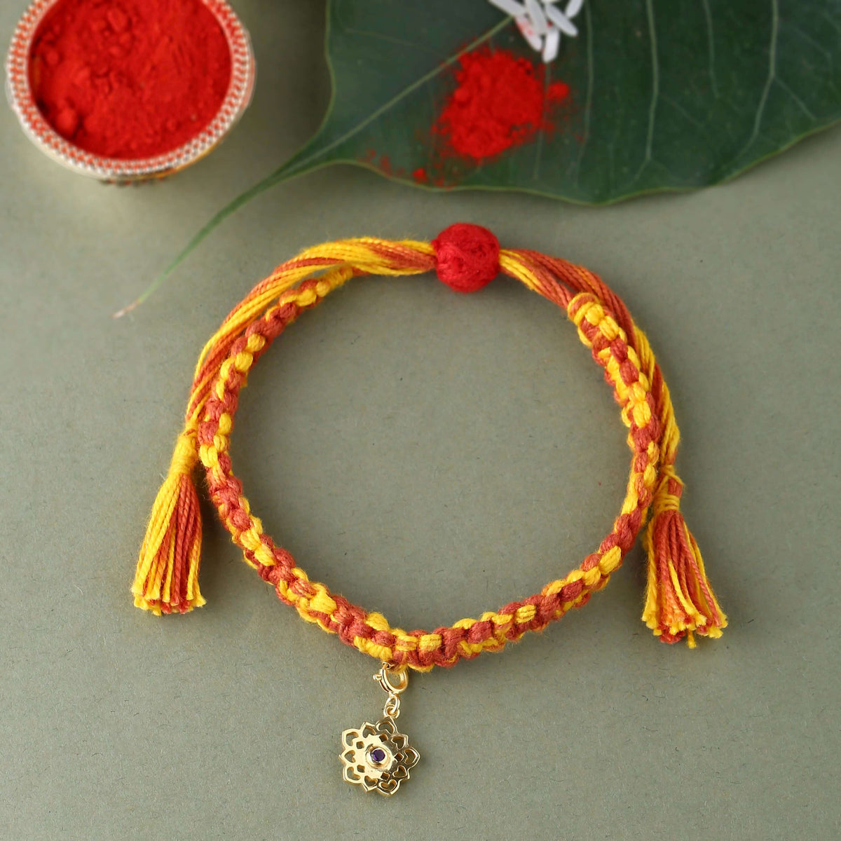 Gold Sahasrara chakra rakhi studded with Amethyst Gemstone