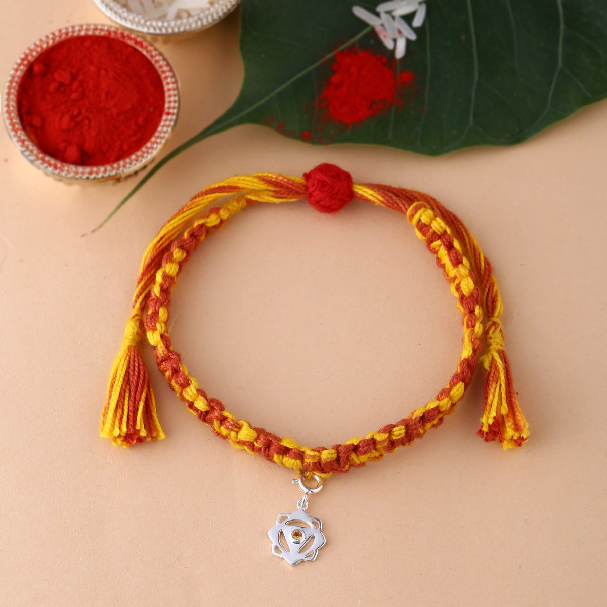 silver Manipura chakra rakhi studded with Citrine gemstone
