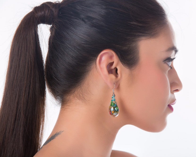 illuminating bulb shaped earrings filled with dyed flowers