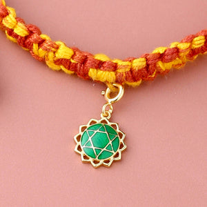 Anahata chakra gold rakhi in braided mauli