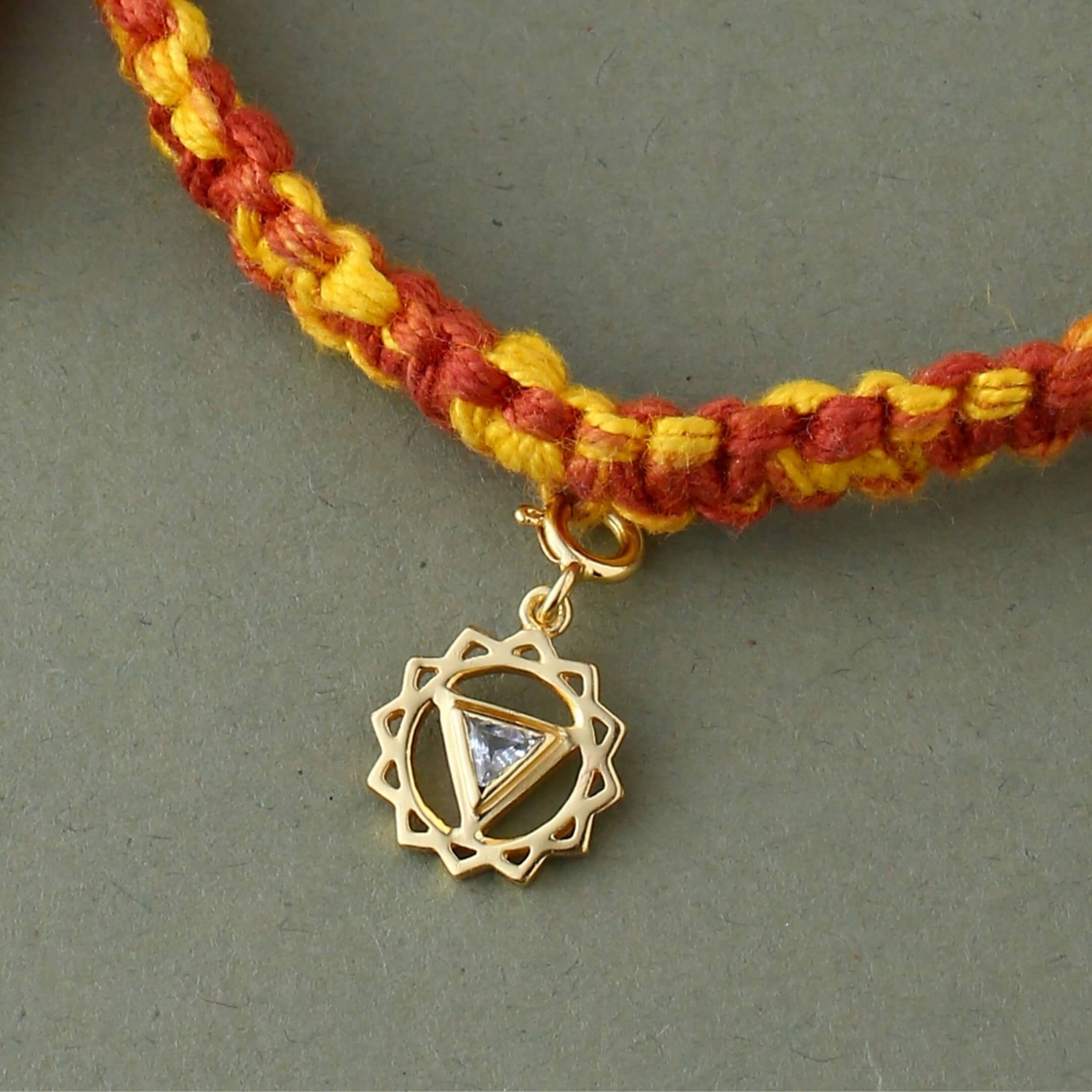 Vishuddha chakra gold rakhi in braided mauli