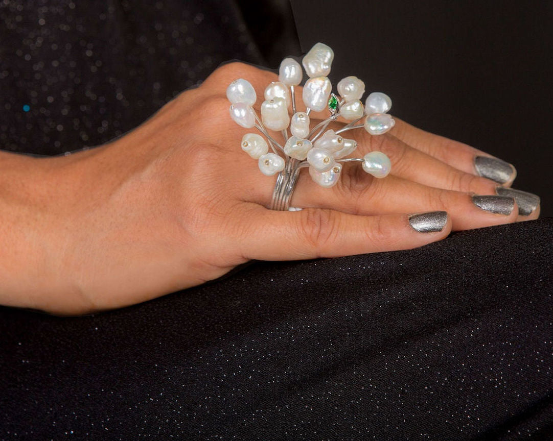 Finger adorned with fresh water baroque pearl ring