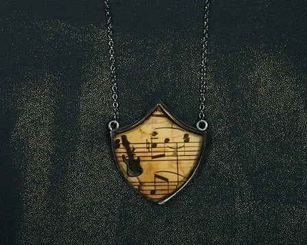Guitar musical shield neckpiece