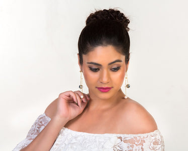 Front view of the model with meenakari pearl earrings